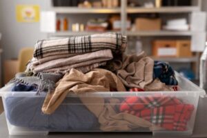 Winter scarves and blankets packed in a clear tub for self storage Brisbane